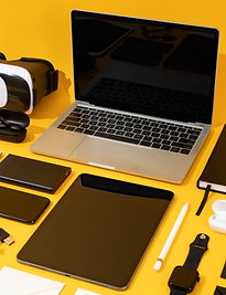 Consumer electronics arranged on a yellow background